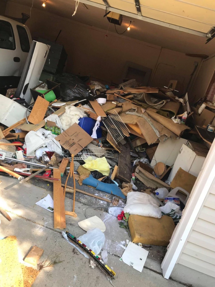 Garage packed with junk before a Junk Genies cleanout